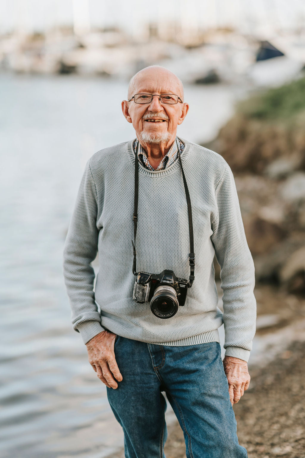 Don Tuma standing on the coast with his camera