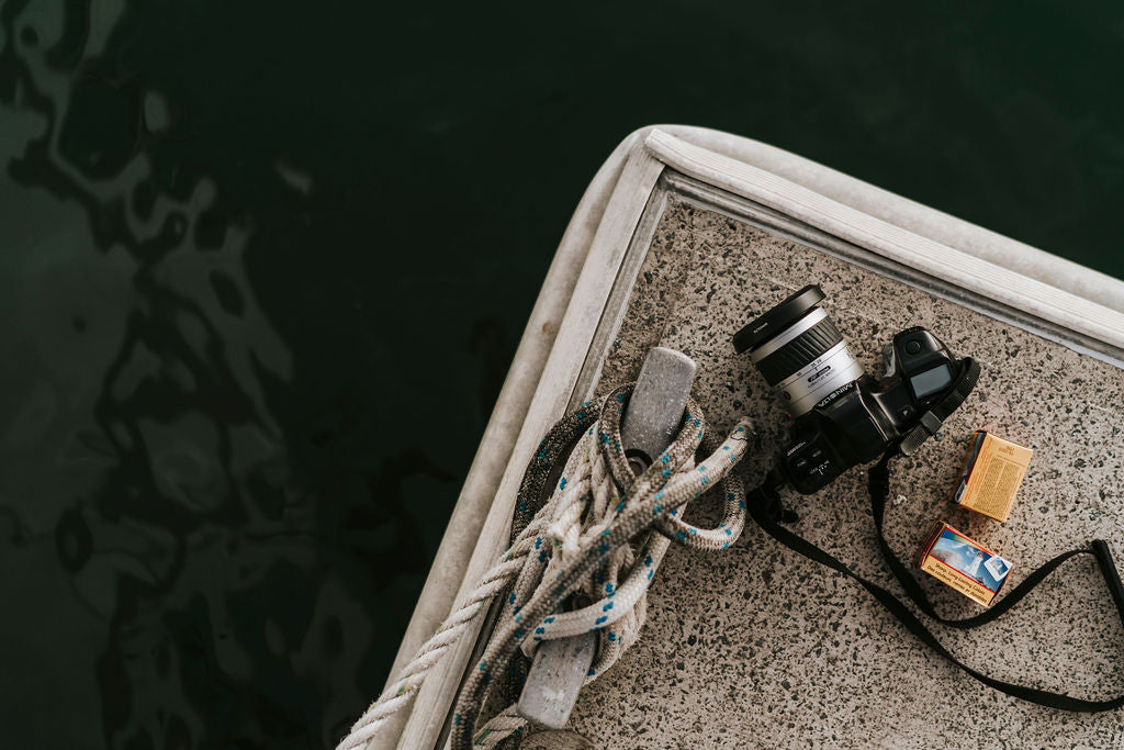 Don Tuma’s camera and photographs beside the water